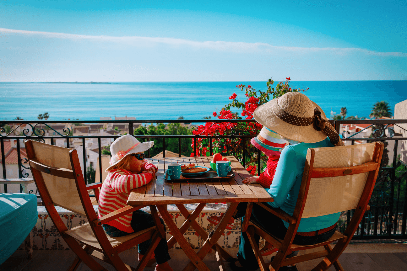 A Marbella terrace at golden hour, overlooking the sea