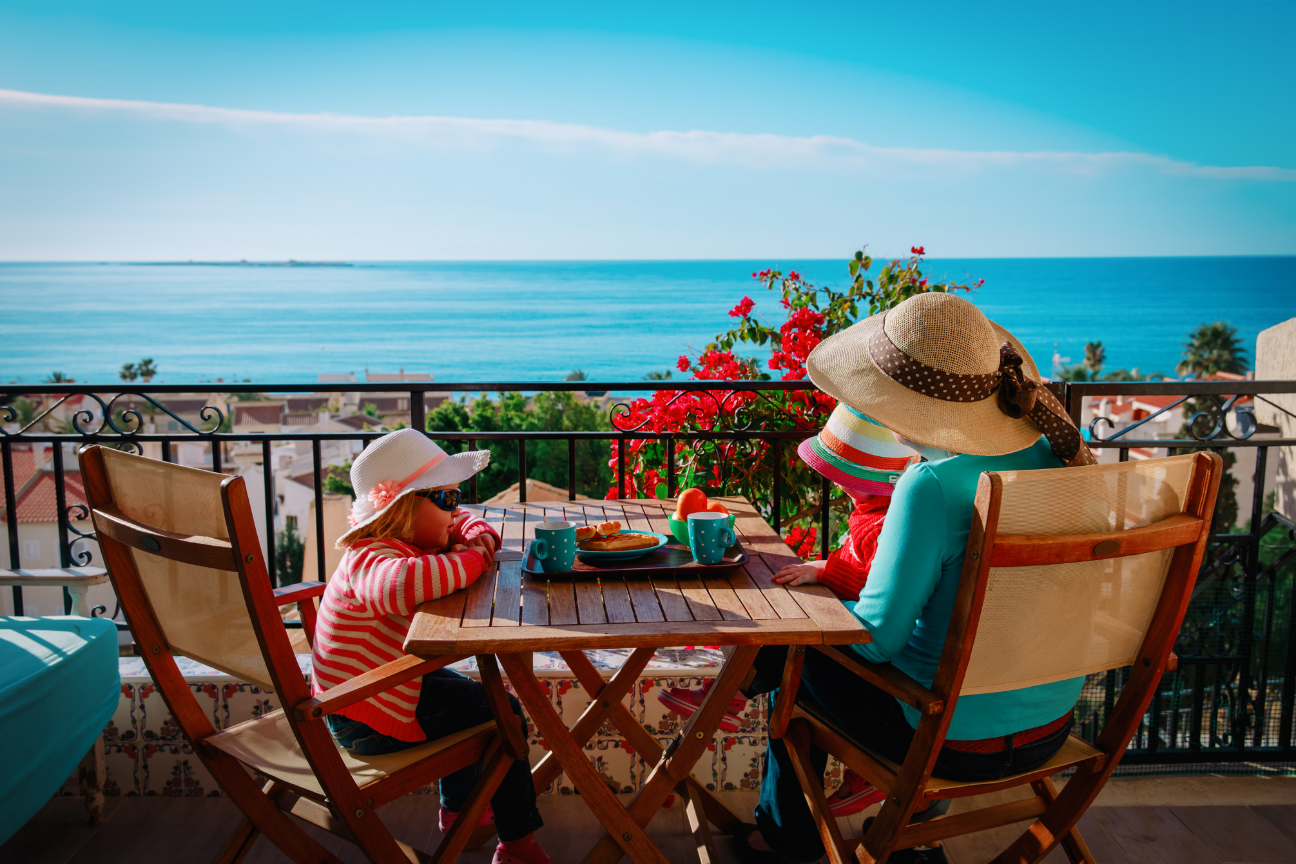 A Marbella terrace at golden hour, overlooking the sea